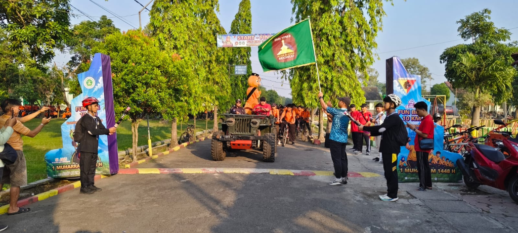 FUN BIKE - Komandan Kikav Panser Sumput Kapten Reza Eko Nugroho didampingi Waka Kurikulum SMK YPM 8 Sidoarjo memberangkatkan ribuan siswa yang mengikuti Fun Bike 10 KM peringatan 1 Muharram 1448 Hijriyah, Selasa (16/06/2026).