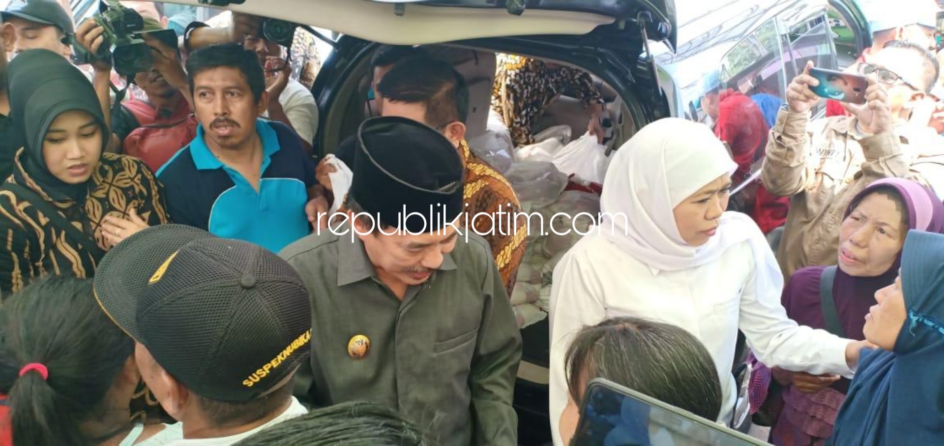 JUALAN - Gubernur Jatim, Khofifah Indar Parawansa didampingi Plt Bupati Sidoarjo, Nur Ahmad Syaifuddin melayani warga yang membeli beras dan gula di Pasar Ngaban, Kecamatan Tanggulangin, Sidoarjo, Sabtu (18/01/2020).