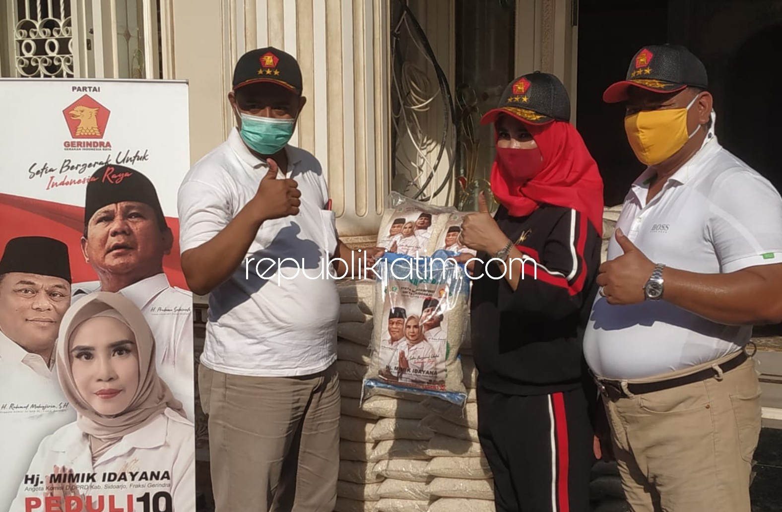 BAGIKAN - Anggota Komisi III DPR RI, Rahmat Muhajirin bersama istrinya anggota DPRD Sidoarjo, Mimik Idayana membagikan 500 paket beras 5 kilogram untuk 500 warga terdampak Covid-19, Jumat (10/04/2020).