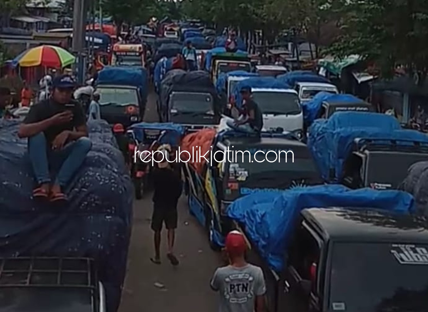 MENGULAR - Pelaksanaan Pembatasan Sosial Berskala Besar (PSBB) membuat para pedagang Pasar Porong, Sidoarjo merasa dirugikan dan memicu antrean panjang mengular mobil pikup dan truk pengangkut buah dan sayur, Kamis (30/04/2020).