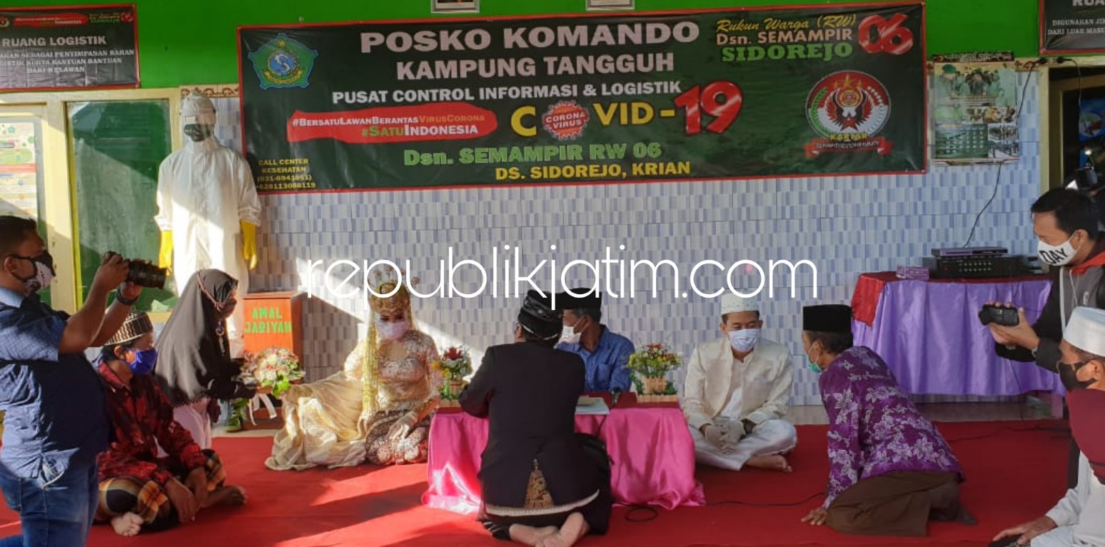 MENIKAH - Prosesi akad nikah mempelai Agus Triana dan Umi Nadziroh berlangsung di Posko Kampung Tangguh RW 06 Dusun Semampir, Desa Sidorejo, Kecamatan Krian, Sidoarjo, Jumat (05/06/2020).