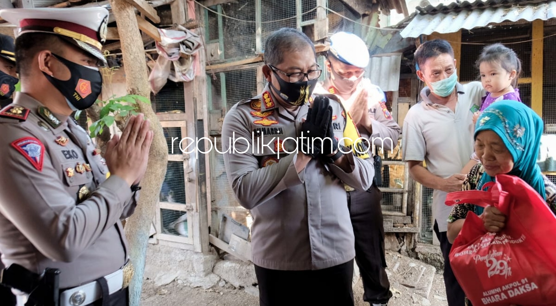 SERAHKAN BANTUAN - Kapolresta Sidoarjo Kombes Pol Sumardji turun langsung secara door to door ke rumah warga menyerahkan bantuan ke warga Desa Cemengkalang, Kecamatan Sidoarjo, Selasa (28/07/2020).