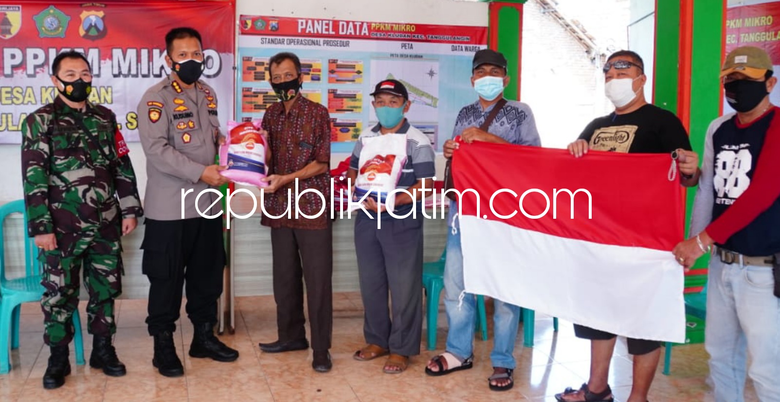 SERAHKAN - Kapolresta Sidoarjo Kombes Pol Kusumo Wahyu Bintoro, pejabat utama dan Forkopimka Tanggulangin menyerahkan 50 paket sembako dan bendera merah putih untuk pelaku UMKM Desa Kludan, Kecamatan Tanggulangin, Sidoarjo, Sabtu (07/08/2021).