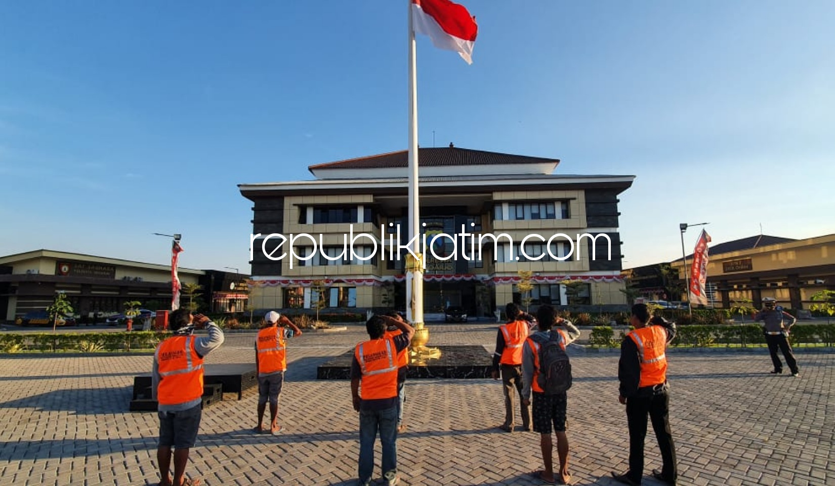 HORMAT - Para pelanggar protokol kesehatan disanksi hormat bendera merah putih di halaman Polresta Sidoarjo saat terjaring razia di Check Point JL Raya Cemengkalang, Sidoarjo, Senin (07/09/2020) petang.