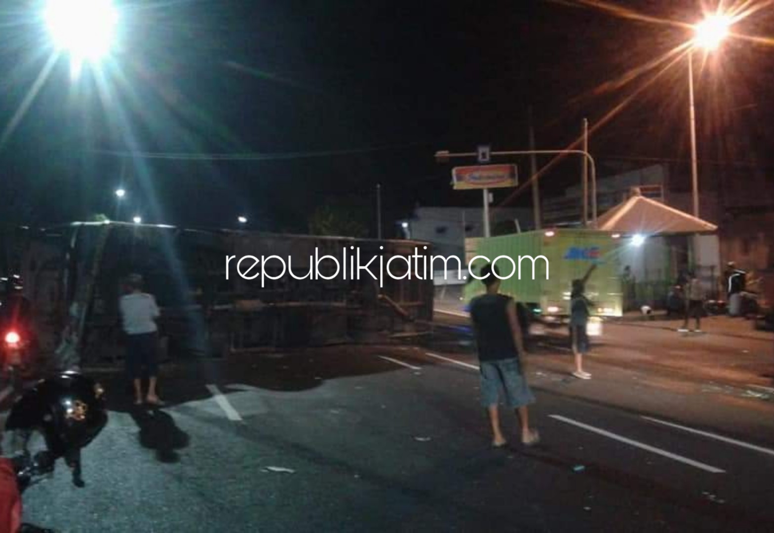 MELINTANG - Kondisi Bus Mira melintang dan menutup jalan raya Surabaya - Mojokerto di Desa Wonokupang, Kecamatan Balongbendo, Sidoarjo, Jumat (19/10/2018) dini hari.