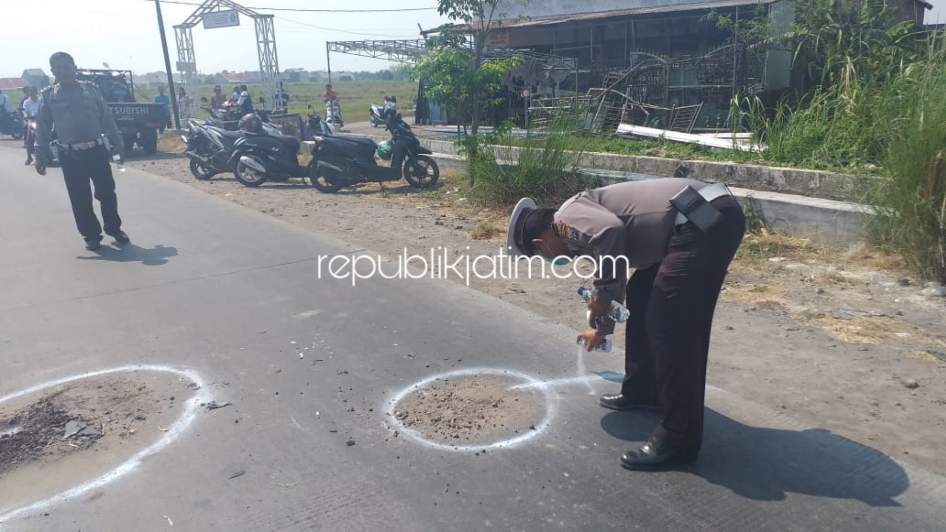 OLAH TKP - Sejumlah petugas Unit Laka, Satuan Lantas, Polresta Sidoarjo menggelar Olah TKP dua pengendara motor yang tewas ditabrak dump truk di JL Raya Desa Wilayut, Kecamatan Sukodono, Sidoarjo, Kamis (24/10/2019).