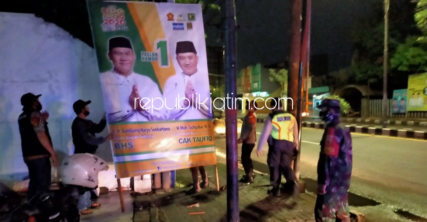TERTIBKAN - Sejumlah petugas gabungan menertibkan Alat Peraga Kampanye (APK) Cabup dan Cawabup Sidoarjo karena memasuki masa tenang, Minggu (06/12/2020) dini hari. 