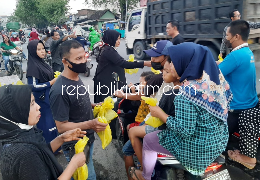 BAGI TAKJIL - Adinda dan anggota Ananda Talent School Sidoarjo saat membagikan takjil dan bukber di samping perempatan lampu merah JL Raya Prambon - Mojosari bersama Anjal, Sabtu (16/04/2022) petang.