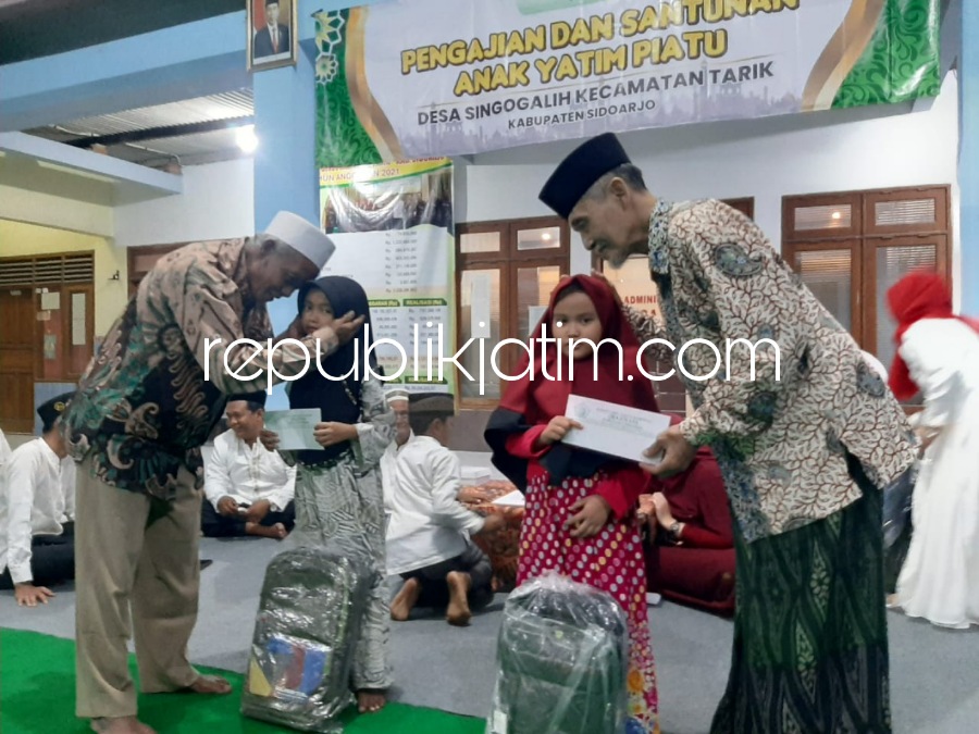 SANTUNAN - KH Amin Abbas, tokoh masyarakat dan Kades Singogalih memberikan bingkisan santunan kepada anak yatim piatu di pendopo desa setempat, Sabtu (03/09/2022) malam. 