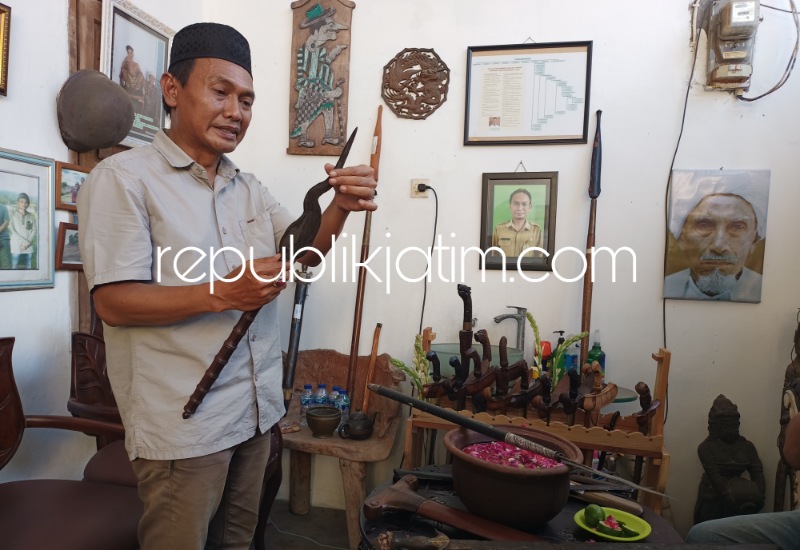 JAMASAN - M Wildan salah seorang warga Perumahan Gebang Raya, Desa Gebang, Kecamatan Sidoarjo menjamas sekitar 40 benda pusaka warisan leluhur di depan rumahnya sehari sebelum 1 Suro atau 1 Muharram 1445 Hijriyah, Selasa (18/07/2023) sore.